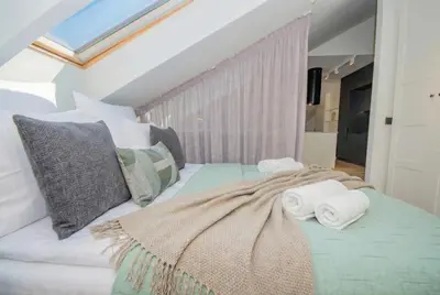 a bedroom with a bed with towels on it at InPoint Sunny Studio next to Wawel Castle - Kossaka 5 Self Check-in in Kraków