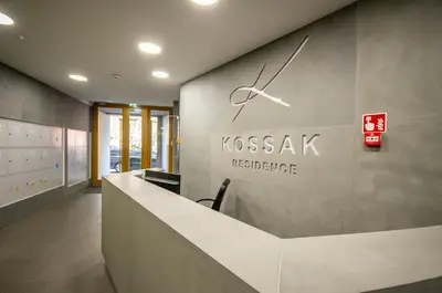 a reception desk with a clock on a wall at InPoint Sunny Studio next to Wawel Castle - Kossaka 5 Self Check-in in Kraków