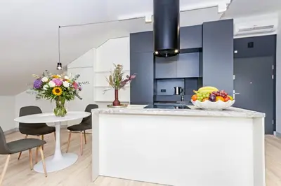 a kitchen with a counter with a bowl of fruit on it at InPoint Sunny Studio next to Wawel Castle - Kossaka 5 Self Check-in in Kraków