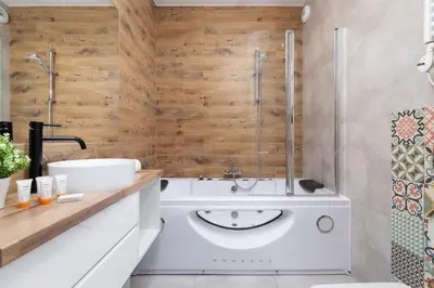 a bathroom with a tub and a sink and a shower at Luxurious Apartment Rakowicka Kraków by Renters Prestige in Kraków