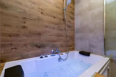 a bathroom with a tub and a shower at Luxurious Apartment Rakowicka Kraków by Renters Prestige in Kraków