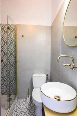 a bathroom with a sink and a toilet and a shower at Wiślna Main Square Apartments in Kraków
