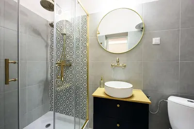 a bathroom with a shower and a sink and a mirror at Wiślna Main Square Apartments in Kraków