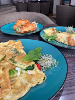 three blue plates of food on a table at Wiślna Main Square Apartments in Kraków