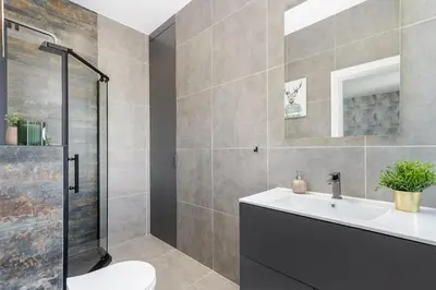 a bathroom with a sink and a shower at Basztowa Apartments by VSI in Kraków