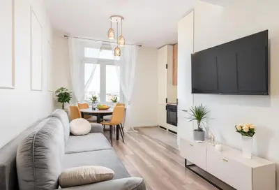 a living room with a couch and a table at Basztowa Apartments by VSI in Kraków