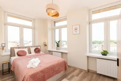 a bedroom with a bed with two towels on it at Basztowa Apartments by VSI in Kraków