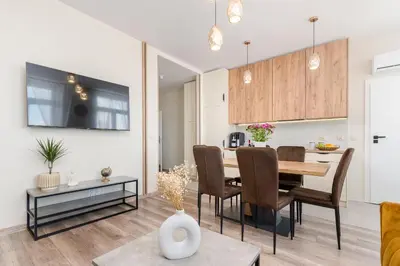 a dining room and kitchen with a table and chairs at Basztowa Apartments by VSI in Kraków