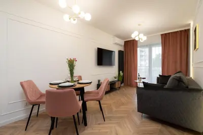 a living room with a table and a couch at Exclusive Royal Apartment in Kraków