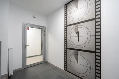 a hallway with a door and a mirror at Exclusive Royal Apartment in Kraków