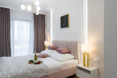a bedroom with a bed with a tray of food on it at Exclusive Royal Apartment in Kraków