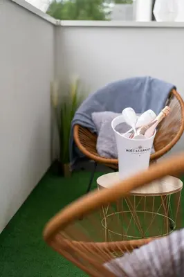 a wooden chair with a toothbrush and a cup on it at Exclusive Crystal Apartment in Kraków