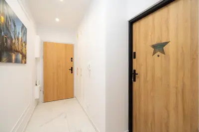 a hallway with a door with a star on it at Exclusive Crystal Apartment in Kraków