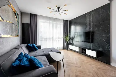 a living room with a couch and a television at City of the Kings - Podskale 18 in Kraków