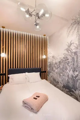 a bedroom with a bed with a towel on it at City of the Kings - Podskale 18 in Kraków