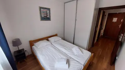 a small bedroom with a bed with two towels on it at Apartament przy Łąkach - Zakodomki (Kraków) in Kraków