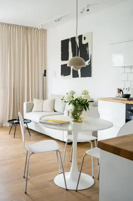 a white living room with a white table and chairs at Unique & Modern Apartment Zabłocie in Kraków
