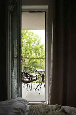 a door leading to a patio with a table and chairs at Unique & Modern Apartment Zabłocie in Kraków