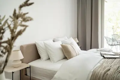 a bed with white sheets and pillows in a room at Unique & Modern Apartment Zabłocie in Kraków