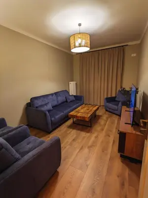 a living room with two couches and a coffee table at Spacious Two-Bedroom Apartment in the City Center in Kraków
