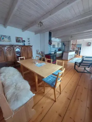 a living room with a wooden table and a couch at Villa Marlena - basen, balia, grill, billard, ogród i relaks in Spytkowice