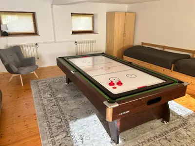 a living room with a pool table in the middle at Villa Marlena - basen, balia, grill, billard, ogród i relaks in Spytkowice