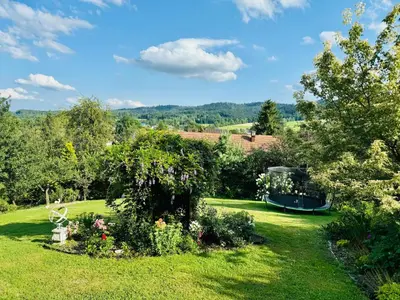a garden with a gazebo in the grass at Villa Marlena - basen, balia, grill, billard, ogród i relaks in Spytkowice