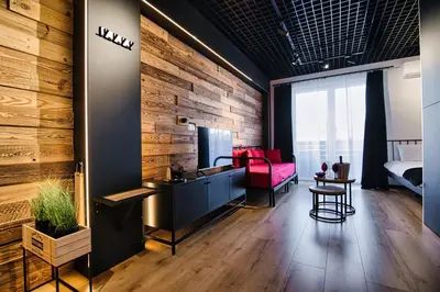 a living room with a red couch and a bedroom at Zadzior4 by Housine in Zator