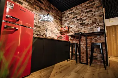 a kitchen with a red refrigerator and a brick wall at Zadzior4 by Housine in Zator