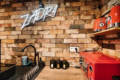 a kitchen with a brick wall and a sink at Zadzior4 by Housine in Zator