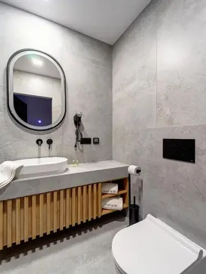 a bathroom with a sink and a mirror and a toilet at Stek Apartments ApartHotel in Skawina