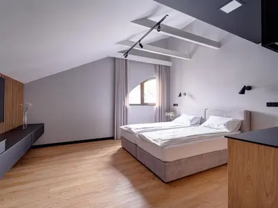 a bedroom with a bed and a ceiling fan at Stek Apartments ApartHotel in Skawina