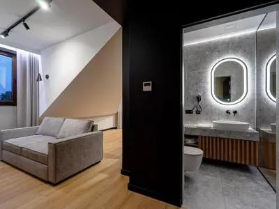 a bathroom with a couch and a sink at Stek Apartments ApartHotel in Skawina