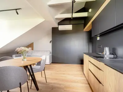 a kitchen and dining room with a table and chairs at Stek Apartments ApartHotel in Skawina