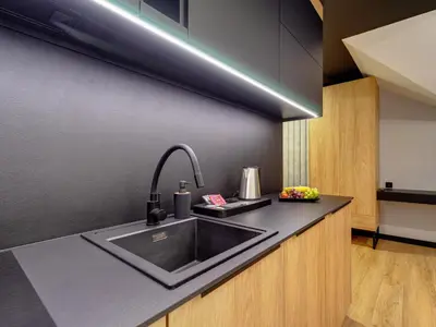 a kitchen with a sink and a counter top at Stek Apartments ApartHotel in Skawina