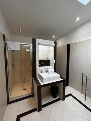 a bathroom with a shower and a sink and a mirror at GOLDEN APARTMENTS with Lift - OLD TOWN in Kraków