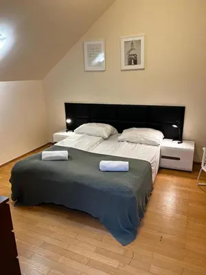 a bedroom with a large bed with two towels on it at GOLDEN APARTMENTS with Lift - OLD TOWN in Kraków