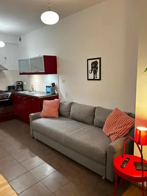 a living room with a couch and a kitchen at GOLDEN APARTMENTS with Lift - OLD TOWN in Kraków