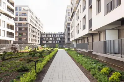 a walkway in the middle of a city with buildings at Zabłocie Beauty Stay in Kraków