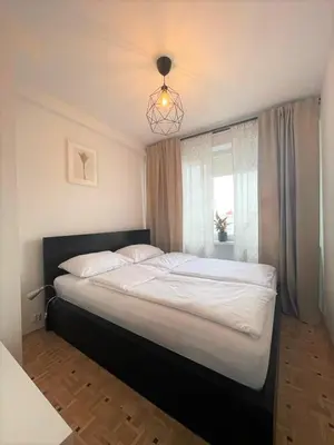 a large bed in a bedroom with a window at Apartament ENJOY Zator - z widokiem na Energylandie in Zator