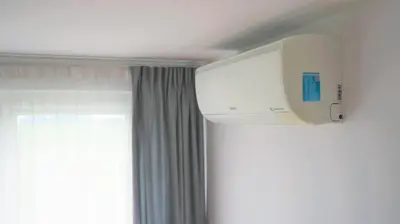 a white chair with a green lunch box on it at Apartament ENJOY Zator - z widokiem na Energylandie in Zator