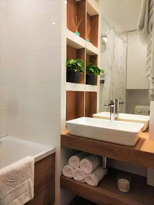 a bathroom with a sink and a tub and a toilet at Apartament ENJOY Zator - z widokiem na Energylandie in Zator