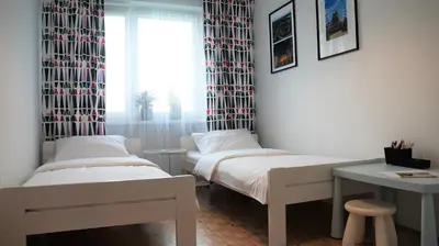 two beds in a room with a window at Apartament ENJOY Zator - z widokiem na Energylandie in Zator