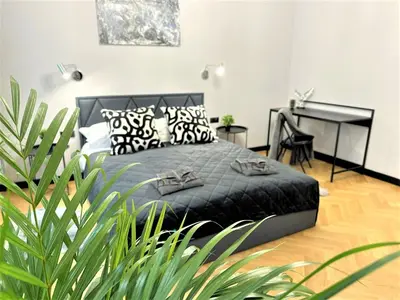 a bedroom with a bed and a desk at LUXURY 100m2 LOFT Design-Apartment at WAWEL + Netflix in Kraków