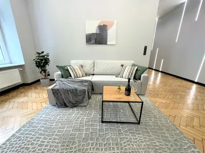 a living room with a couch and a coffee table at LUXURY 100m2 LOFT Design-Apartment at WAWEL + Netflix in Kraków