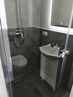 a bathroom with a shower and a toilet and a sink at Zatorska 113 - Zachwycający domek gościnny in Podolsze