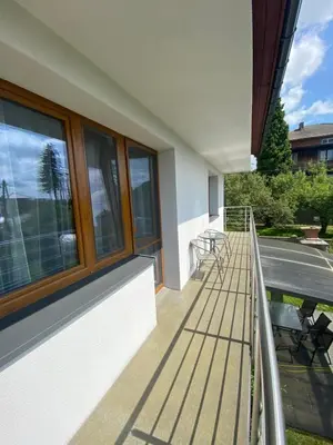 a balcony with windows and a table and chairs at Energylandia Zator noclegi apartament pokoje do wynajęcia in Polanka Wielka