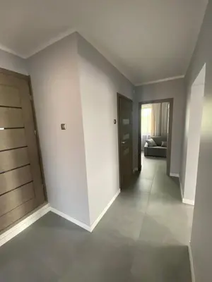 an empty room with a hallway with a door at Energylandia Zator noclegi apartament pokoje do wynajęcia in Polanka Wielka