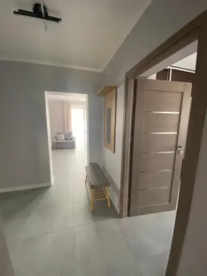 a room with a door and a bench in a room at Energylandia Zator noclegi apartament pokoje do wynajęcia in Polanka Wielka