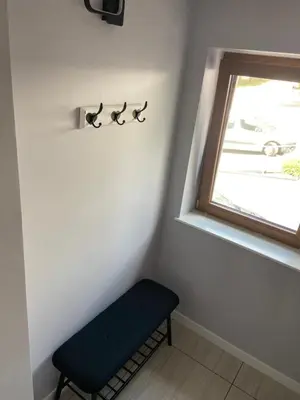 a corner of a room with a bench and a window at Energylandia Zator noclegi apartament pokoje do wynajęcia in Polanka Wielka